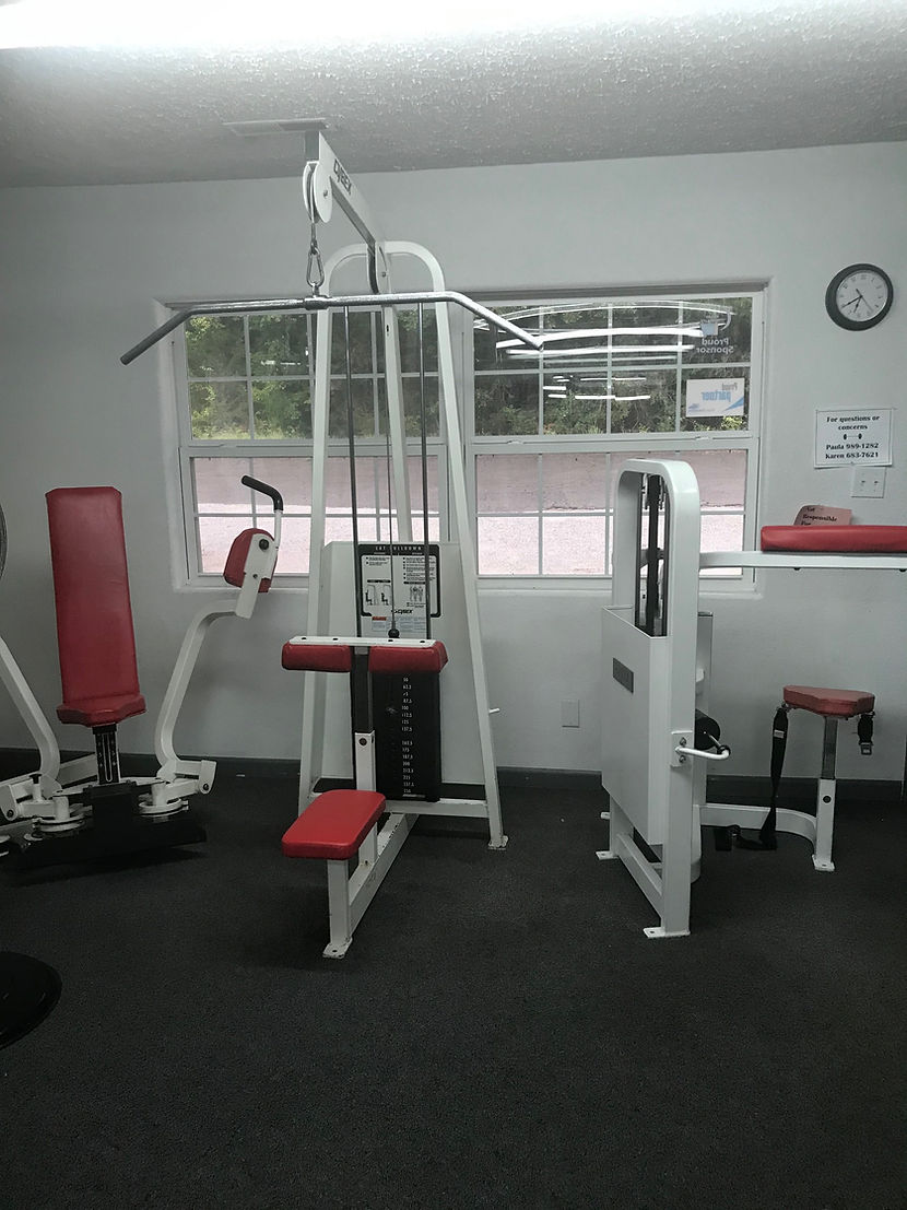 Lat pulldown and strength equipment at Top Dog Fitness Center